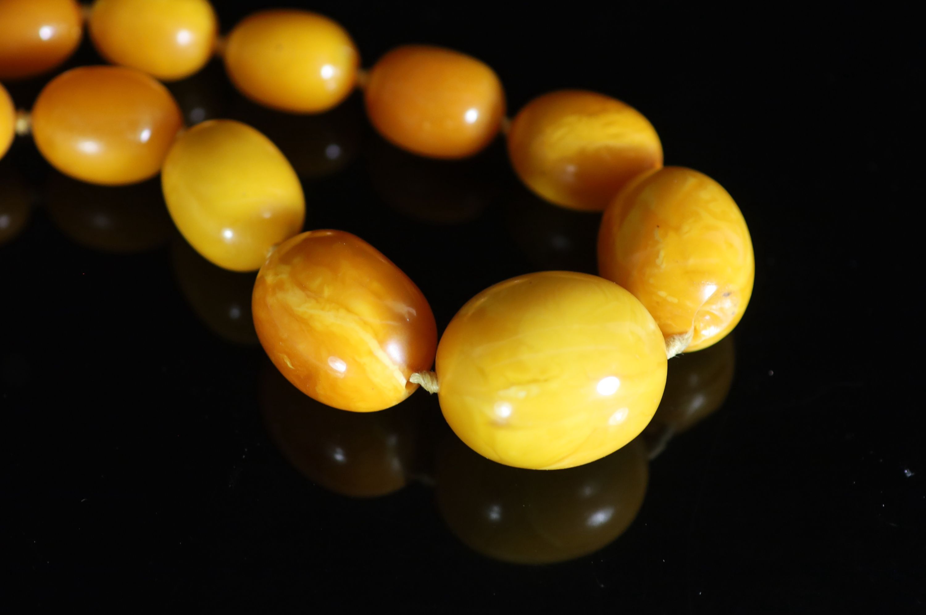 A single strand graduated oval amber bead necklace